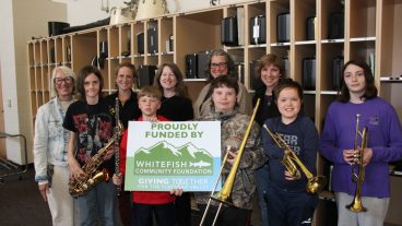 20250424 CFJH Band Students Holding Proudly Funded By Sign